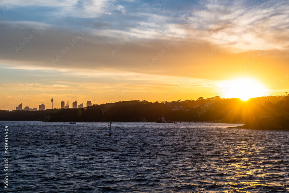 Backlight skyline of Sydney CBD from the bay at sunset