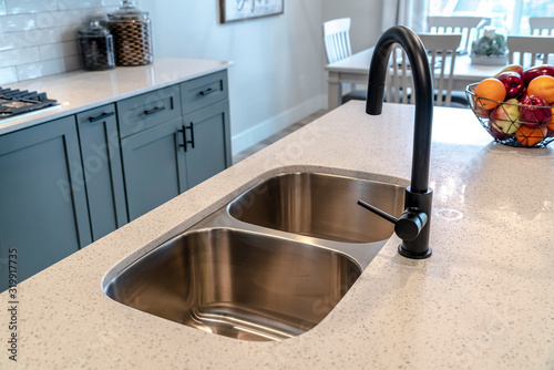 Slika na platnu Stainless steel undermount double basin kitchen island sink with black faucet