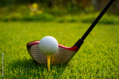 Golf ball and golf club in beautiful golf course at Thailand. Collection of golf equipment resting on green grass background