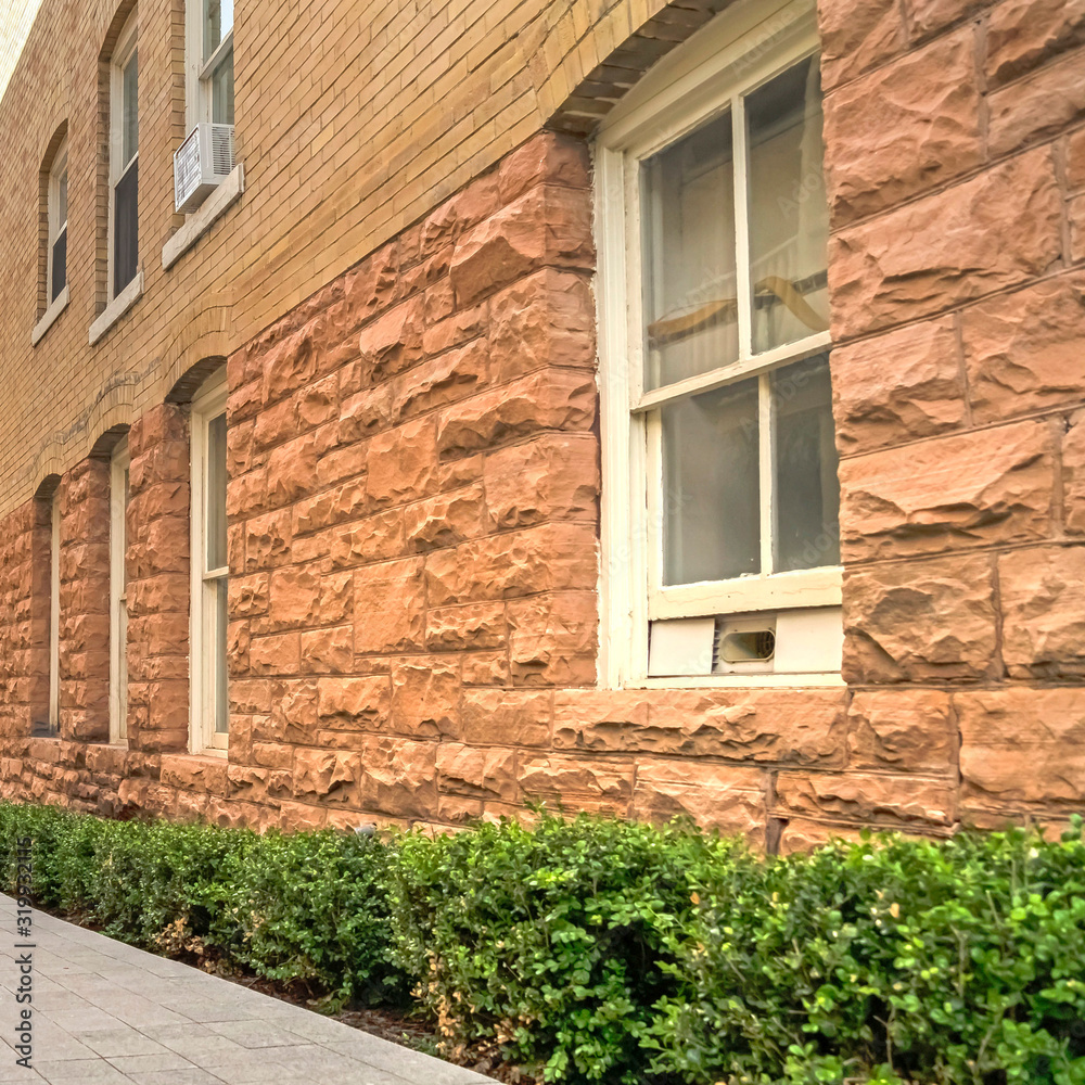 Square frame Pathway amid residential buildings leading to a fire pit in the distance