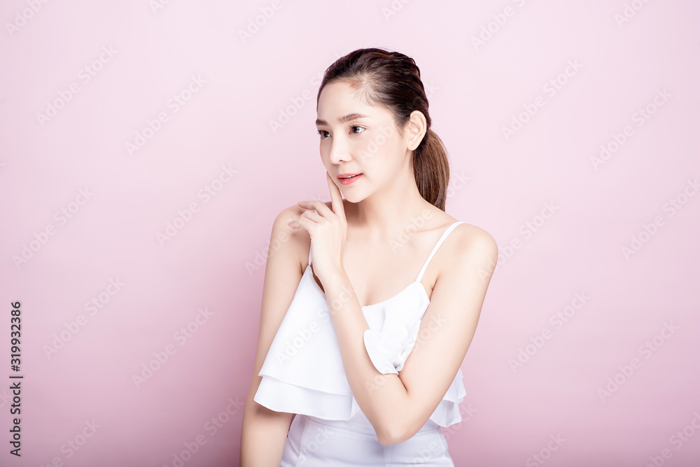 Asian woman poses for healthy skin beauty in pink seamless background. Cosmetic, skincare, surgery concept Asian woman poses for healthy skin beauty in pink seamless background. Cosmetic, skincare, surgery concept