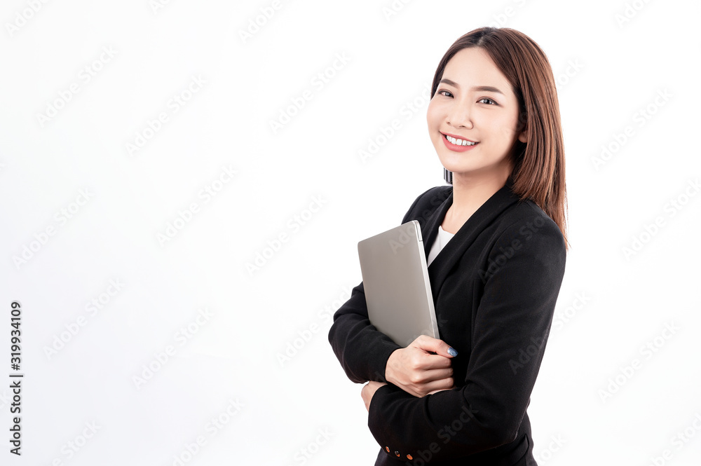 Asian businesswoman with black suit holding a laptop with big smile beaming face in white isolated background. Asian businesswoman with black suit holding a laptop with big smile beaming face in white isolated background.