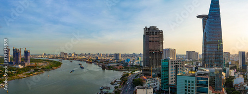 Ho Chi Minh City, Vietnam - CIRCA Jan 2020: Aerial cityscape of Ho Chi Minh City at sunset. The left part of Saigon River is District 2, and the right part is District 1.