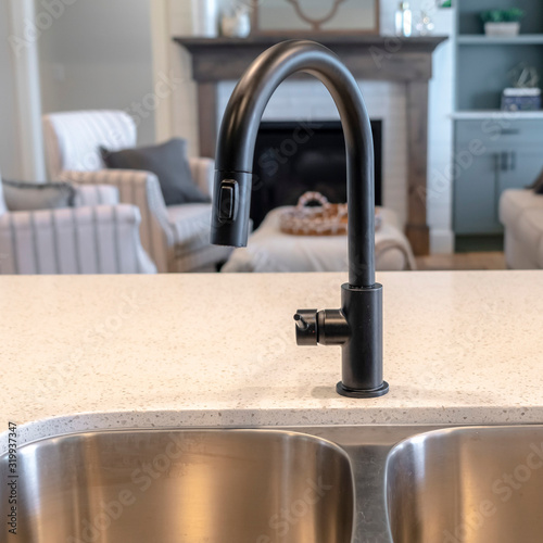Square Double basin undermount sink at the kitchen island of home with black faucet