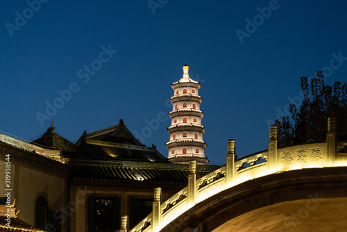 Night view of Yuantong Temple Tower and Yinjian bridge in Beijing Wtown（Gubei Water Town）, China photo