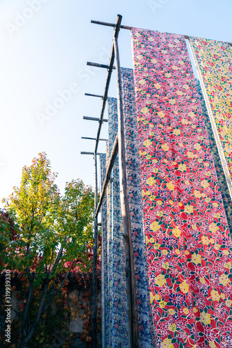 Yongshun Dyeing Workshop, Beijing Wtown（Gubei Water Town）, China. Colorful cloths hanging to dry in the yard. photo