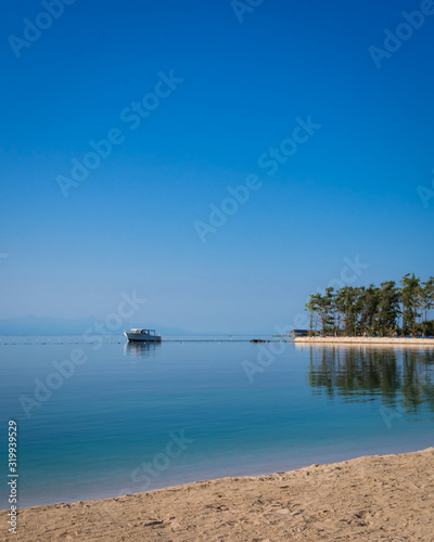 Yacht front caribbean beach with coconut trees at Roatán, Honduras