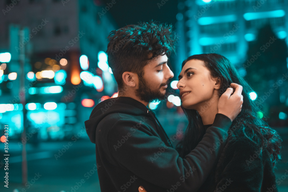 Valentine's Day content, two sweet couples hugging and street themed in lighted blue background. Valentine's day concept pose. Valentine's Day content, two sweet couples hugging and street themed in lighted blue background. Valentine's day concept pose.