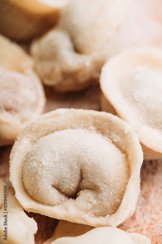 Raw dumplings in flour on the table. Russian national food. Selective focus. Raw dumplings in flour on the table. Russian national food. Selective focus.