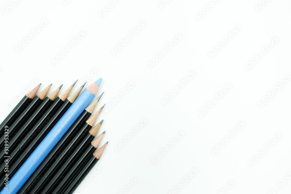 Top view of a group of sharp black pencils and blue pencil in the middle, arranged in a triangle corner isolated on white background with copy space. For leadership, teamwork and goal setting theme Top view of a group of sharp black pencils and blue pencil in the middle, arranged in a triangle corner isolated on white background with copy space. For leadership, teamwork and goal setting theme