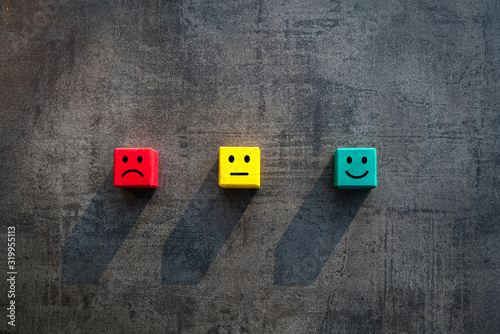 Customer satisfaction measurement unhappy okay and happy faces on coloured red yellow green wood blocks - Commercial business success client rating metrics scale - Excellence, KPI and feedback concept