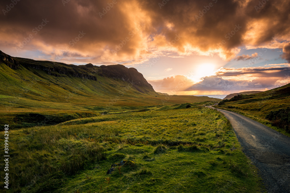 Road to the Scottish highlands at sunset