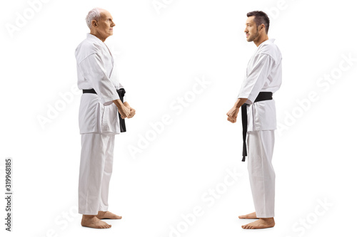 Karate kid standing and looking at his karate instructor