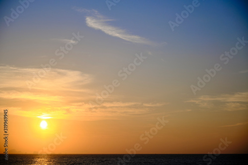 A shot of a beautiful sunrise over the ocean. © adibella6370