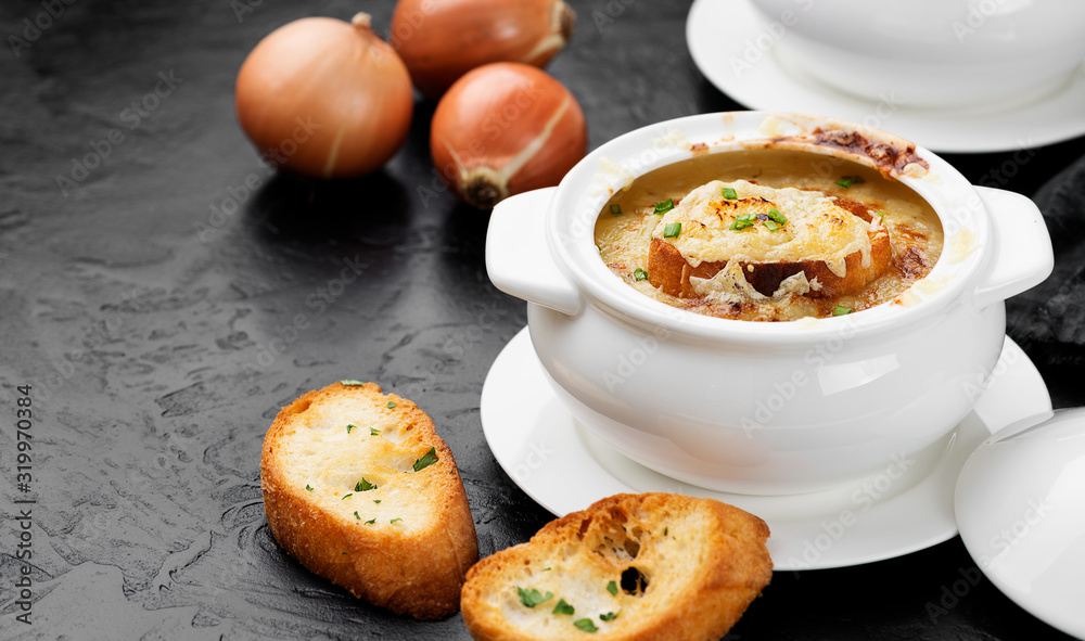Homemade French onion soup with toasted baguette and melted cheese.