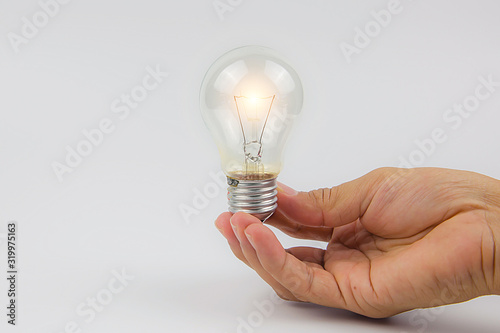 Light bulbs with bright light in hand concetp for creativity, knowledge and organizational leadership.