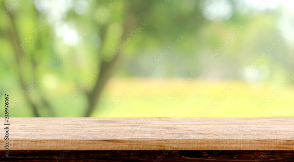blurred background of green park in summer, Wood table top on shiny bokeh green background. For product display