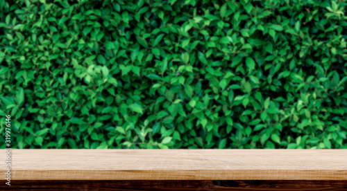 blurred background of green park in summer  Wood table top on shiny bokeh green background. For product display