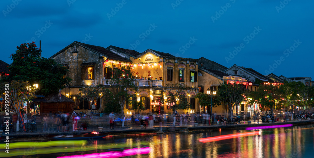 Nightscape at Hoi An old town with passenger boat light trails