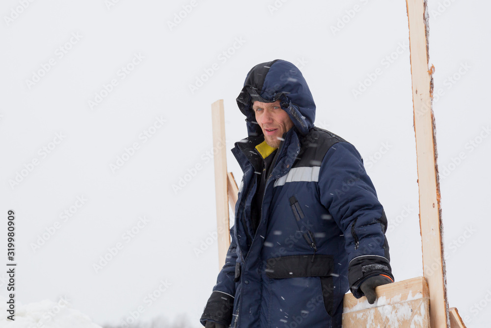Portrait of a worker in overalls at a construction site Portrait of a worker in overalls at a construction site