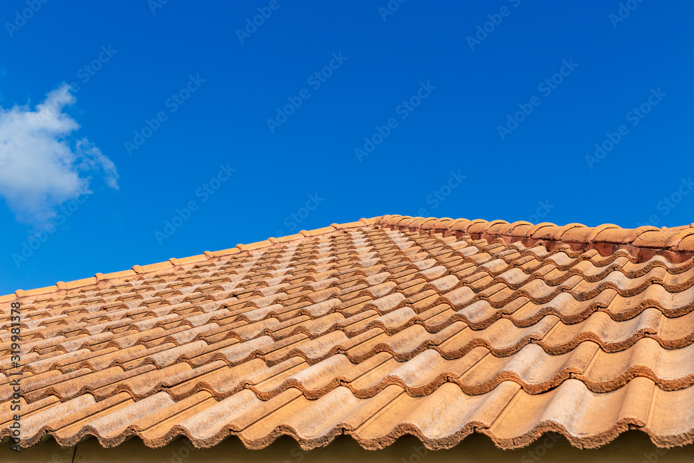 Close up of brown clay roof tiles. Red old dirty roof. Old roof tiles. Construction equipment build a house.