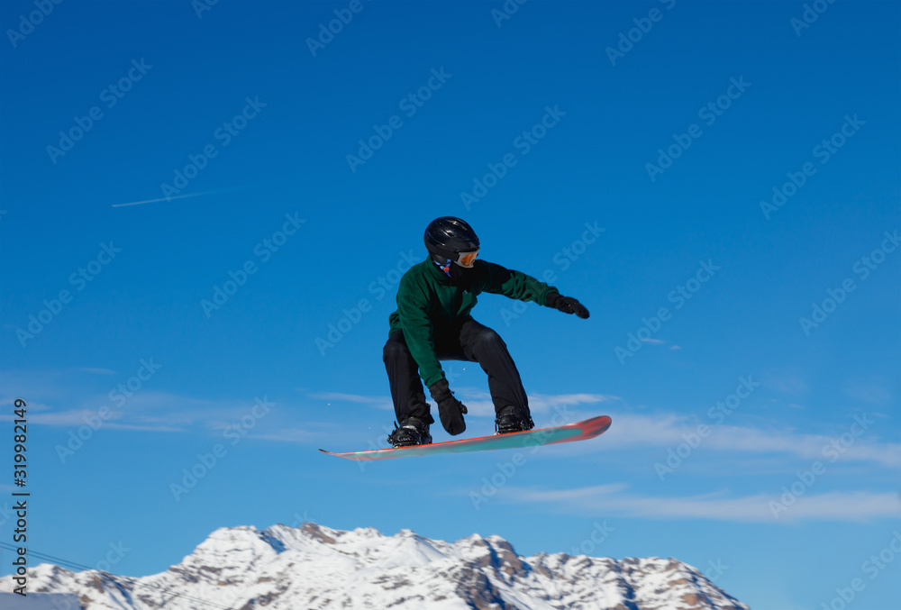 Snowboarder against the blue sky in Livigno, Italy Snowboarder against the blue sky in Livigno, Italy