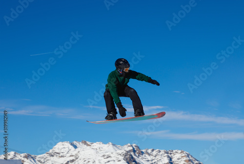 Snowboarder against the blue sky in Livigno, Italy
