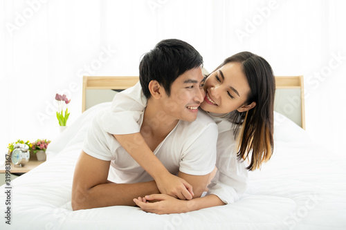 Romantic moment of young Asian couple. A couple making love together on the bed in morning. Valentine concept.