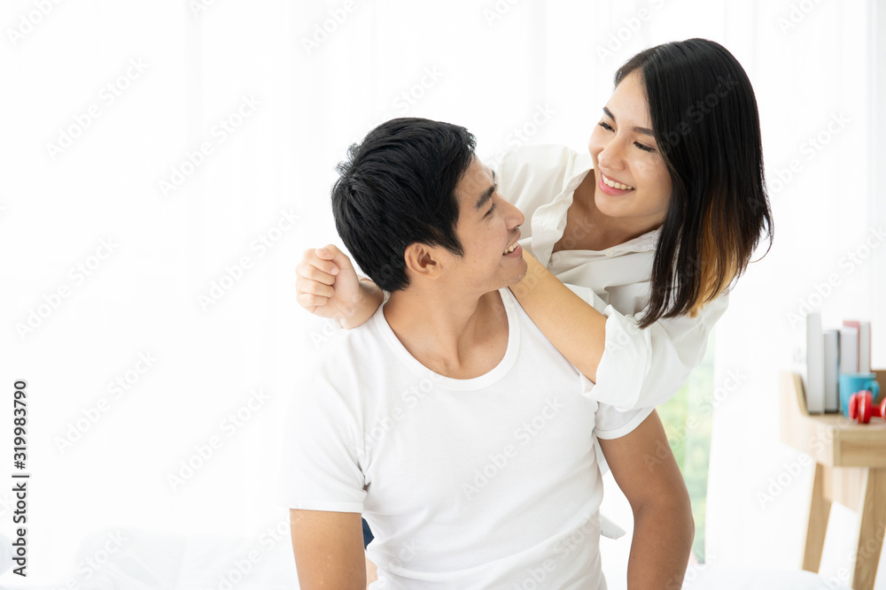 Beautiful Asian couple laying and talking together on the bed. Couple relationship concept. Beautiful Asian couple laying and talking together on the bed. Couple relationship concept.