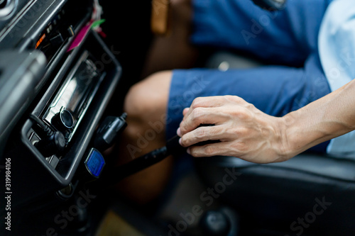 Asian driver holding on a car manual gear stick head (MT) close up.