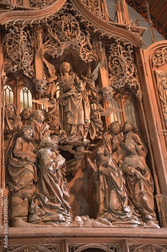 Creglingen (Germany). April 2017. Church of the Body of Christ. Wooden altar made by sculptor Riemenschneider.The farmer, processing the field, found the prosphora-symbol of the Body of Christ.