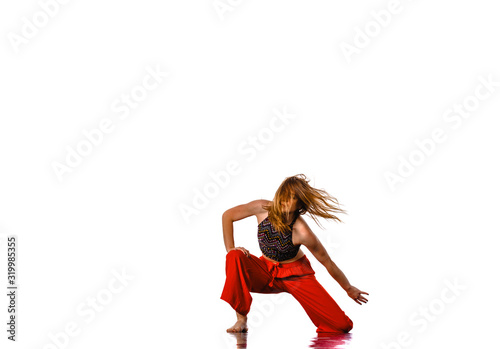 Portrait of young stylish woman street dancer posing in studio