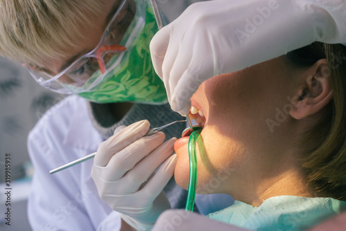Detailed dental examination on a female patient in the dentist's office