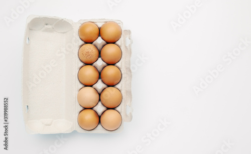 brown chicken eggs in open carton box