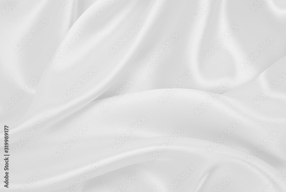 Smooth elegant white silk or satin luxury cloth texture as wedding background. Luxurious background design