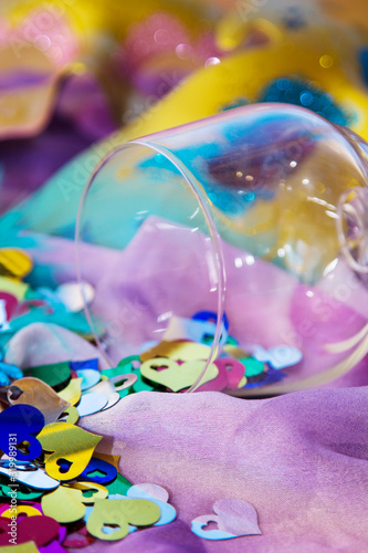 glass cup full of confetti and carnival masks, happy carnival