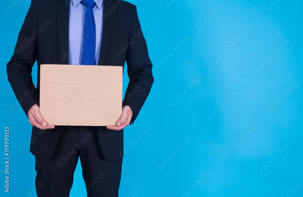 businessman holding an empty poster on blue background businessman holding an empty poster on blue background
