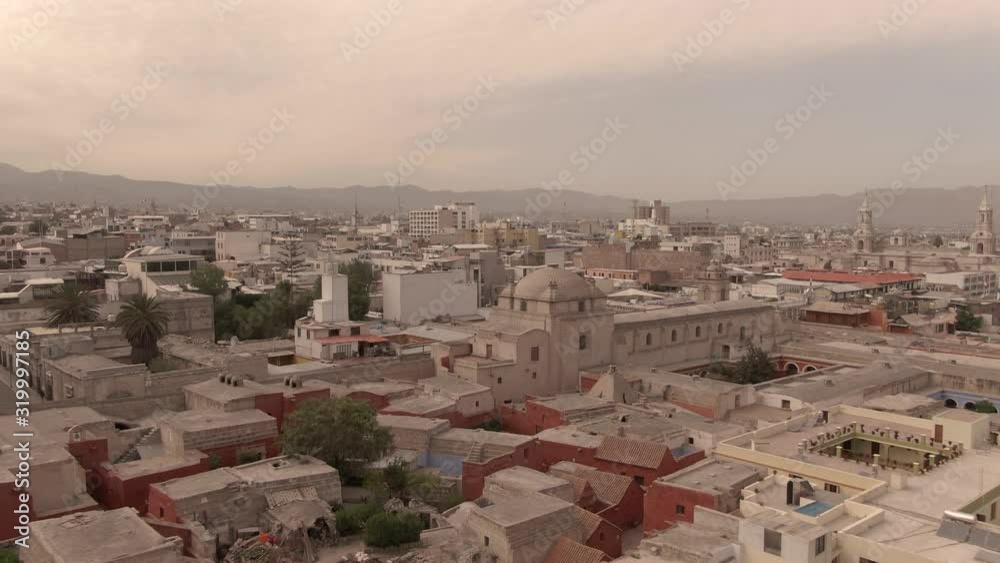 Santa Catalina Monastery with aerial DRONE view of Arequipa, Peru. Scenic, iconic shot, with arches, courtyard, town, buildings, city, and architecture. Landscape cityscape & dramatic view from above Santa Catalina Monastery with aerial DRONE view of Arequipa, Peru. Scenic, iconic shot, with arches, courtyard, town, buildings, city, and architecture. Landscape cityscape & dramatic view from above