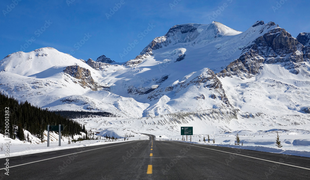 Scenic view of an empty asphalt road leading across scenic Banff National Park