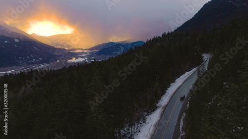 DRONE: Tourists on fun road trip drive up the Sea to Sky Highway at sunrise