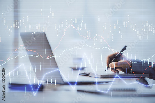 Multi exposure of forex chart with man working on computer on background. Concept of market analysis.
