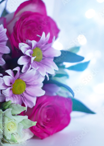 Delicate floral background with copy space under the text. Blurred background with spring flowers, bokeh. Bouquet of flowers close-up
