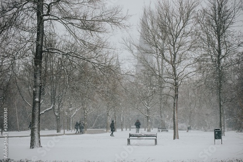 Canvas Print people walking in winter snow park amsterdam holland beench
