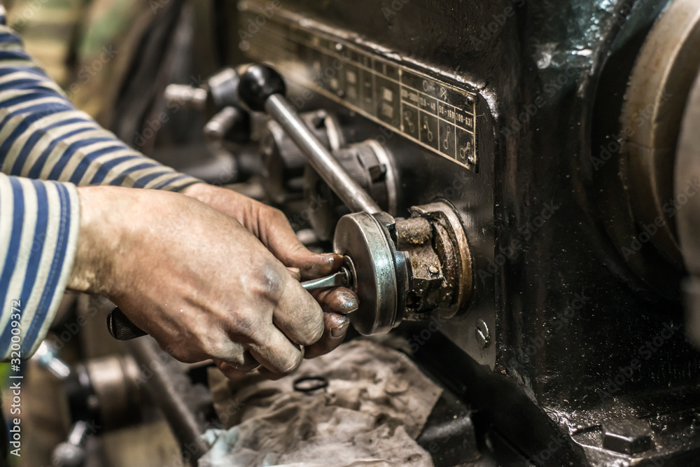 Repair of old metal lathe machine for metalworking closeup in