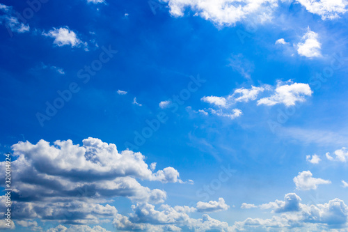 Blue summer sunny sky with white clouds.Background.