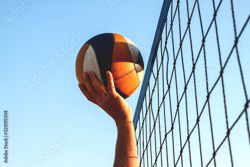 Beach volleyball competition, the ball hit the net, player caught the ball in the net