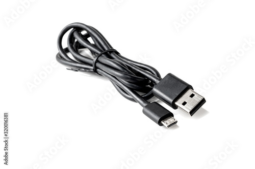 Close-up of a USB cable with standard A and micro-USB standard B connectors isolated on a white background. Black cable for data transfer between devices.
