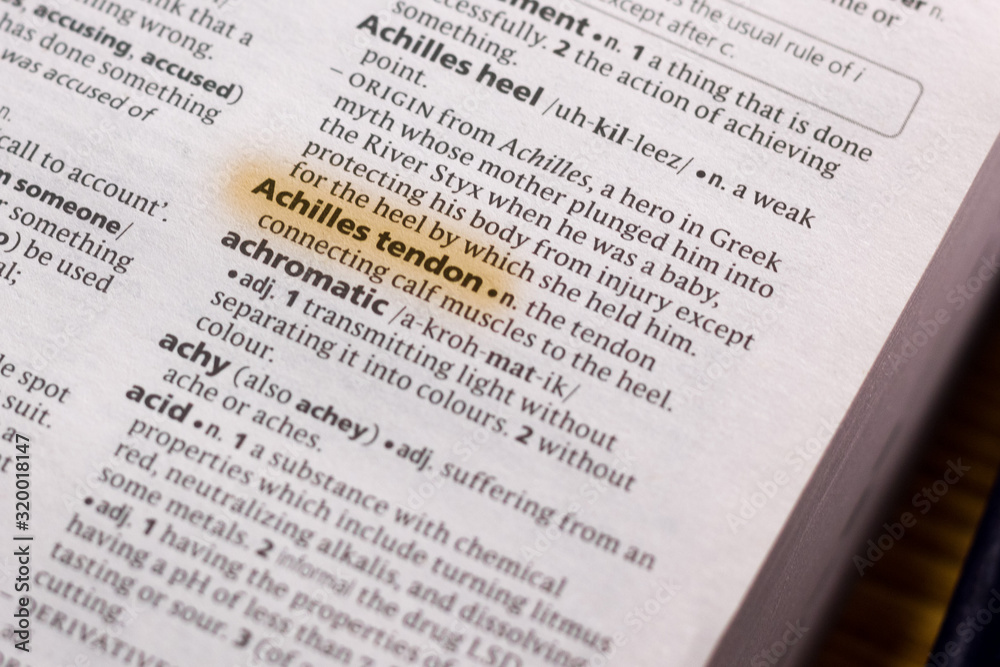 The word or phrase Achilles Tendon in a dictionary. The word or phrase Achilles Tendon in a dictionary.