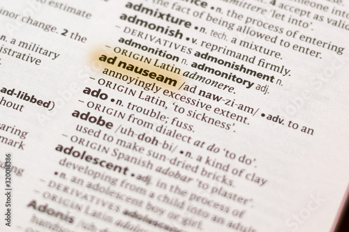 The word or phrase Ad Nauseam in a dictionary. photo