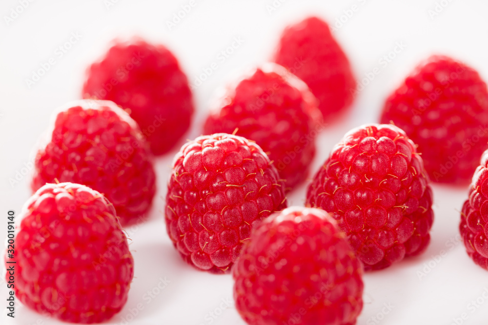 handful of raspberry berries on white background handful of raspberry berries on white background